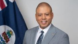 Hon. André Ebanks Premier with Cayman Flag - May 2025 -.jpg